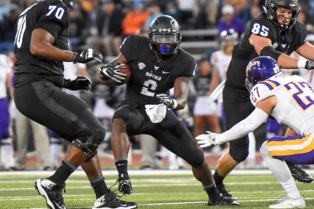 <p>Jordan Johnson jukes out an Albany defender. Johnson signed as an undrafted free agent with the Buffalo Bills.</p>