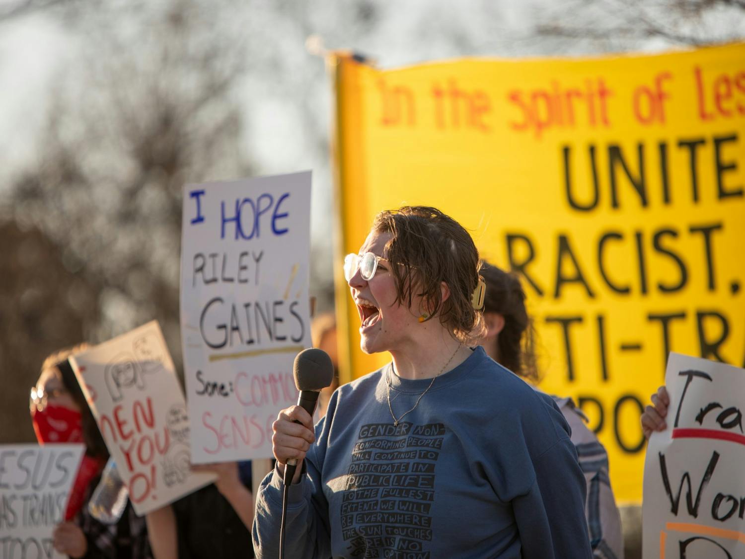 Protestors spoke to attendees through a microphone across the road throughout the night.
