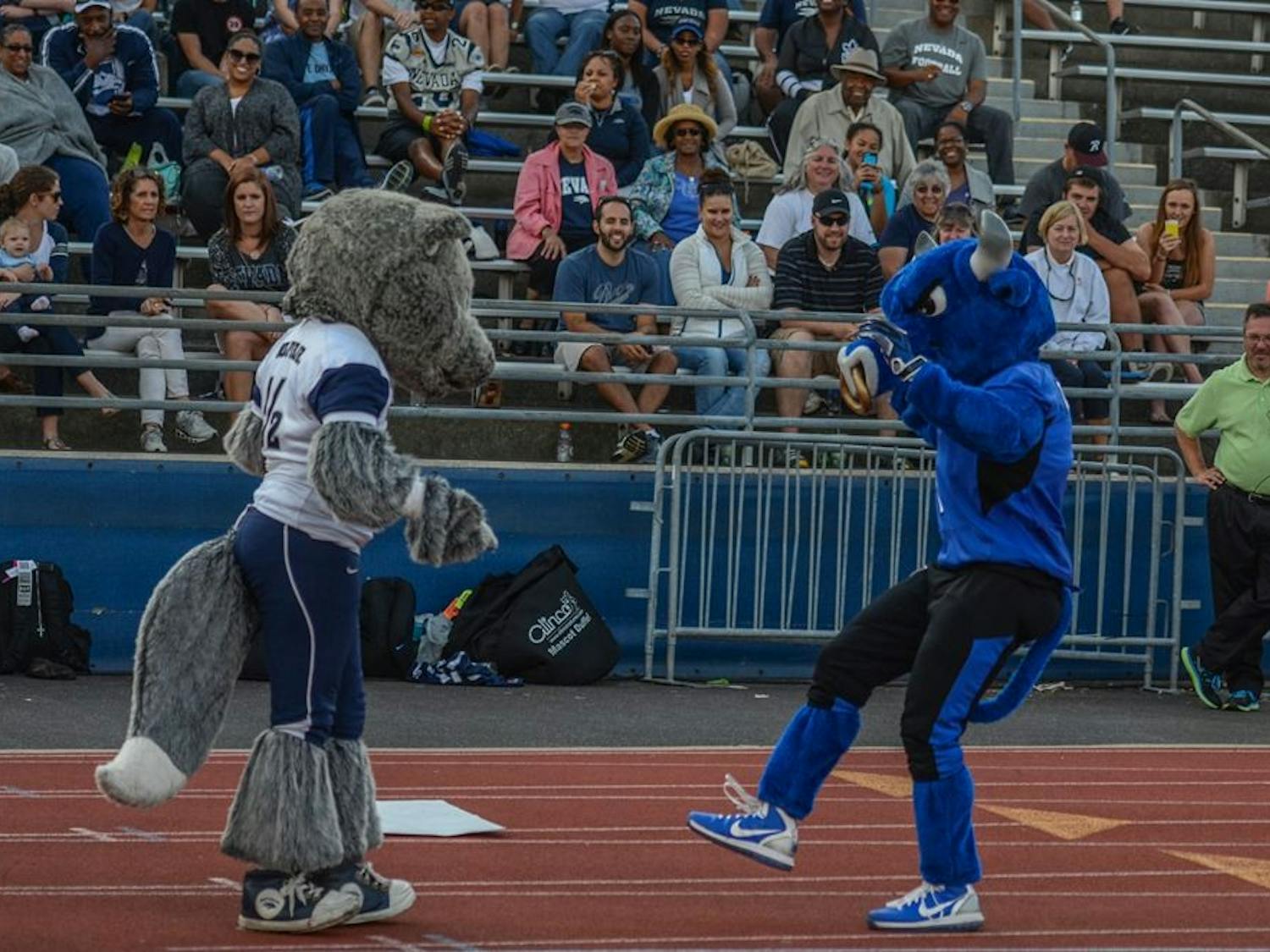 Victor E. Bull (left) interacts with Nevada's mascot Saturday during Buffalo's 24-21 loss at UB Stadium. 