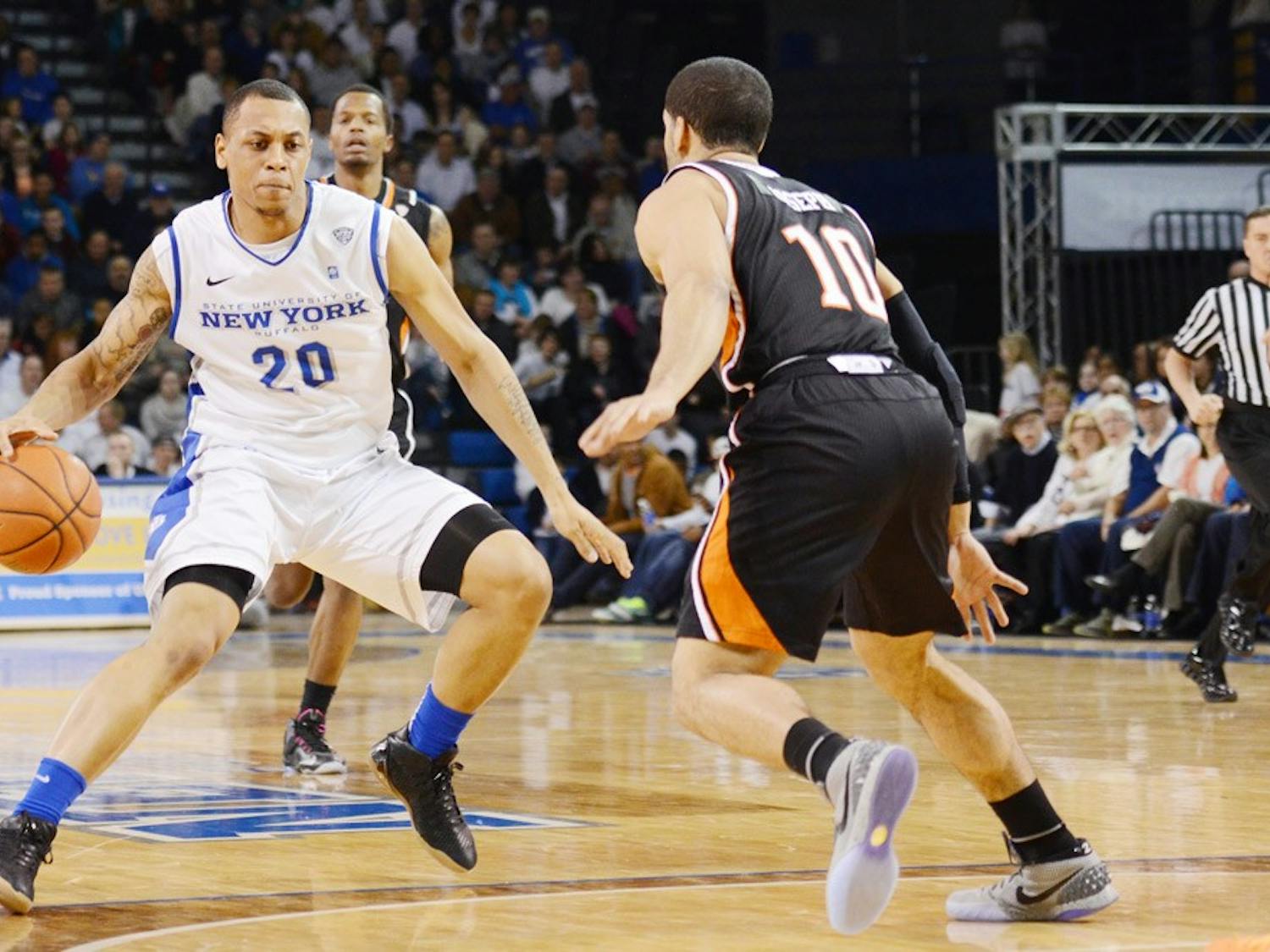 Junior guard Rodell Wigginton crosses over Bowling Green guard David Joseph. Wigginton and the Bulls defeated Kent State on Tuesday and Bowling Green on Friday en route to a triple-bye in the MAC Tournament.