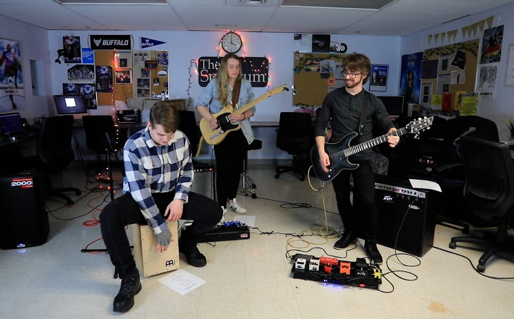 <p>The three-piece rock group, fronted by UB electrical engineering senior Joseph Gogan (left) with guitarists Katie Missert (middle) and Matthew Riley (right), played a raucous set that featured both original songs and a host of classic covers.</p>