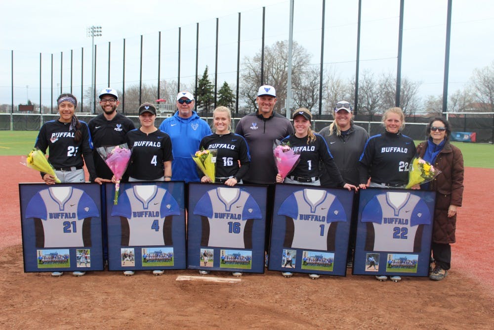 <p>Alysaa Cuevas, Lace Smith, Ally Power, Alissa Karjel and Catrell Robertson stand with members of the UB softball coaching staff and administrators following the end of their doubleheader on Saturday.</p>