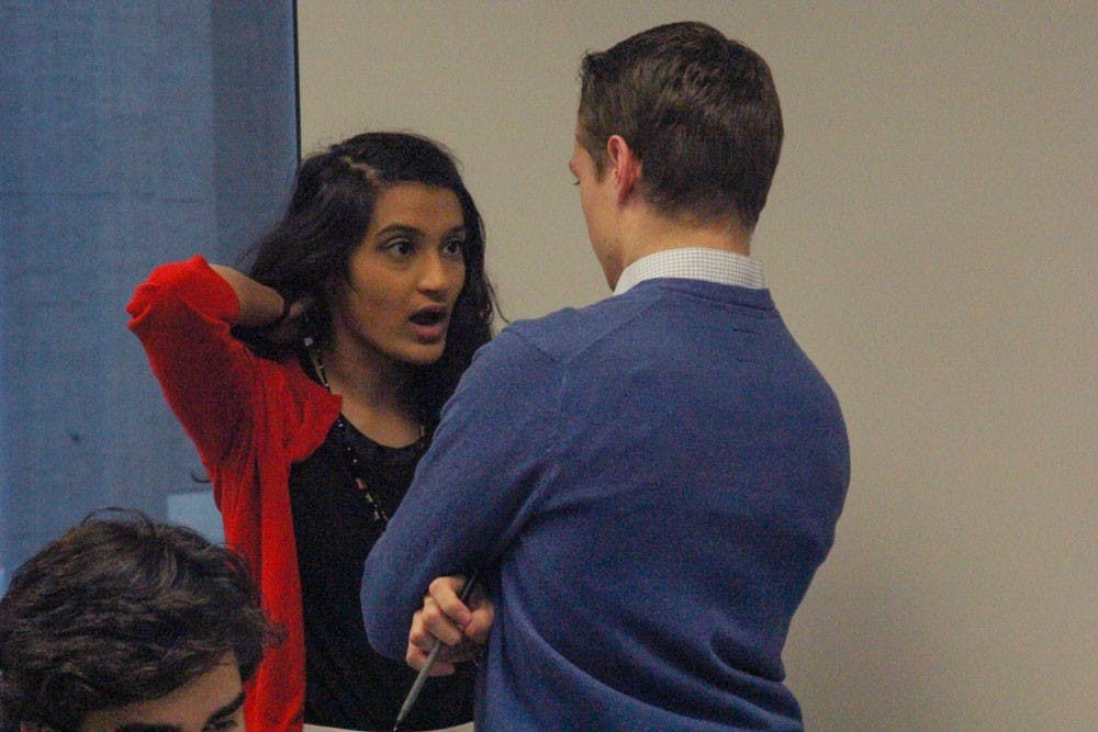 SA President Minahil Khan (left) speaks with Vice President Sean Kaczmarek (right) during Wednesday's Senate Chairperson election. SA Senator Yaser Soliman is accusing Khan or rigging in the election to prevent him from becoming chair.