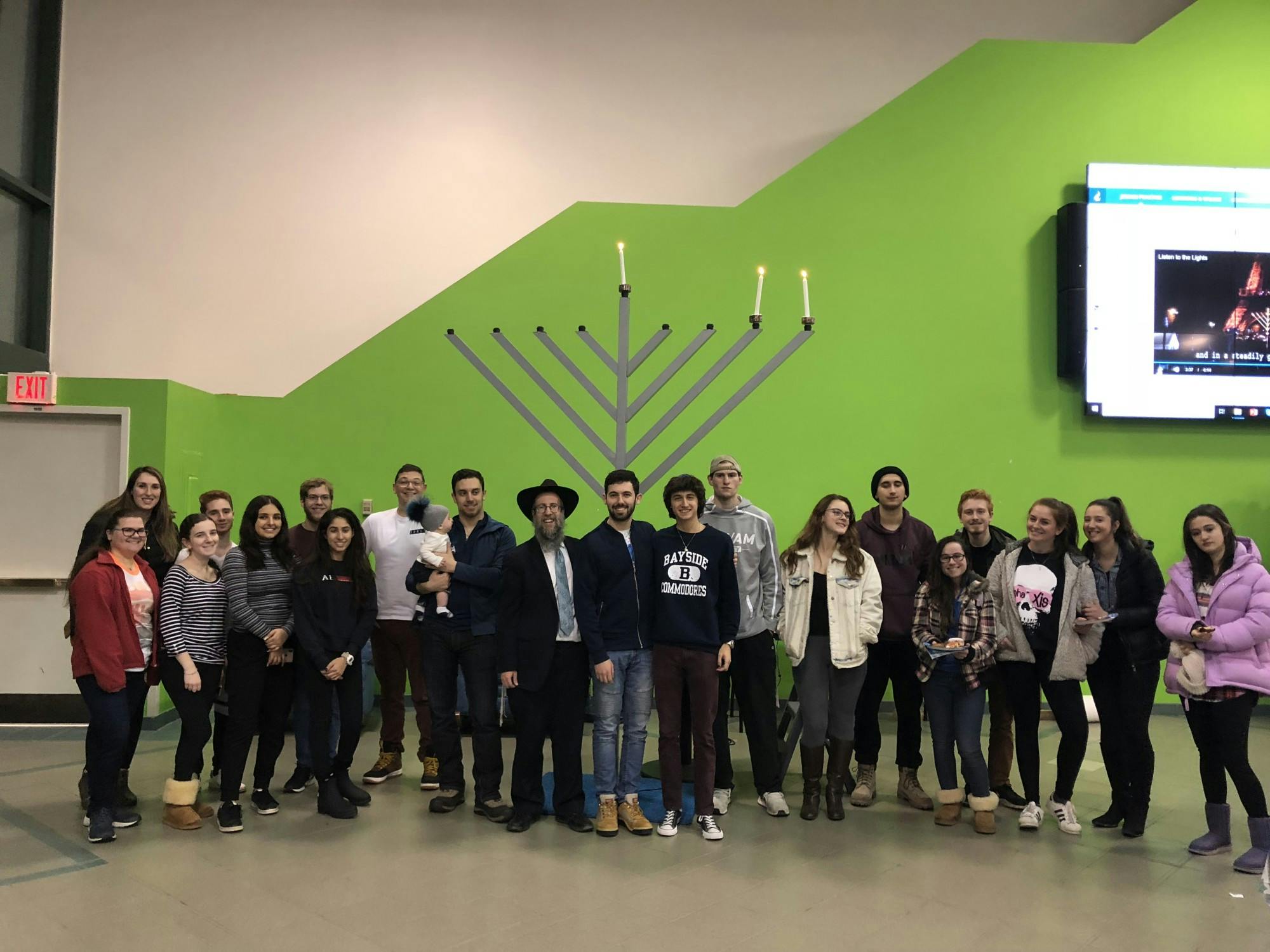 Jewish students pose in front of a menorah in the Student Union in December 2018.