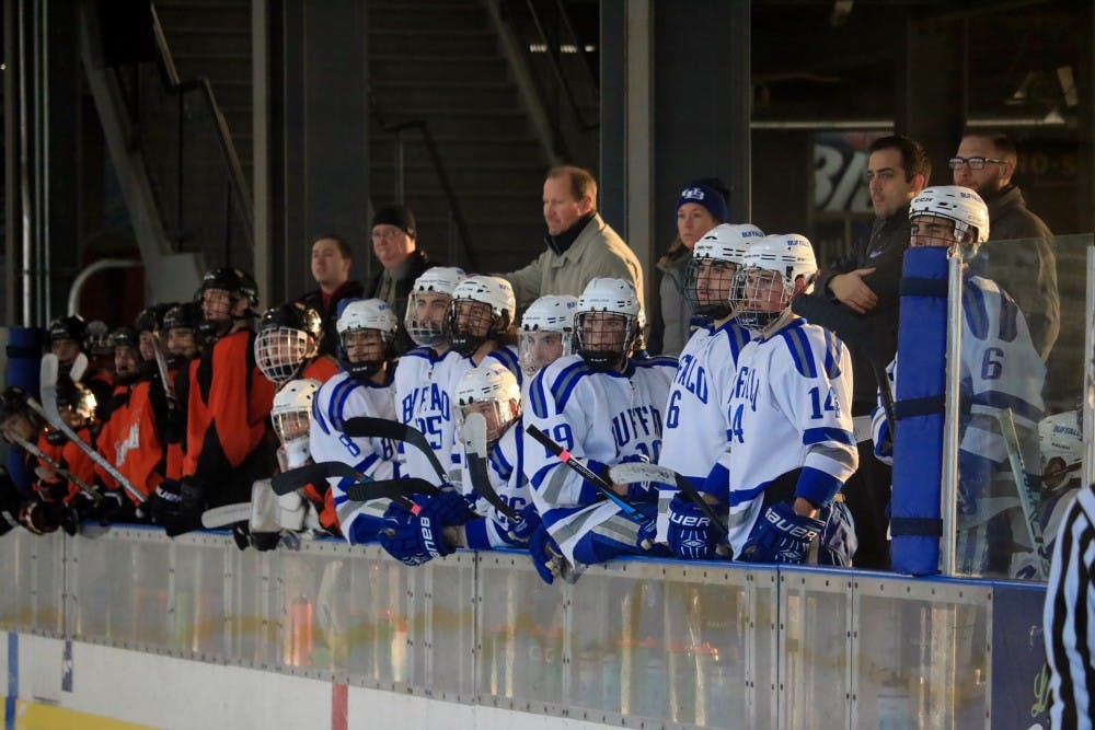 <p>The club hockey team rest on the bench during a game. the team deals with multiple challenges being a club sport.</p>