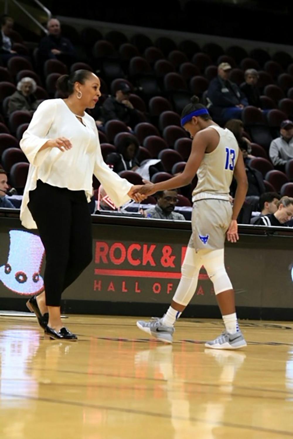 <p>Junior guard Autumn Jones walks to the bench as head coach Felisha Legette-Jack gives her a handshake. The Bulls are playing the Southern Florida Bulls on Saturday at 1:15 p.m. in the first round of the NCAA Tournament.</p>