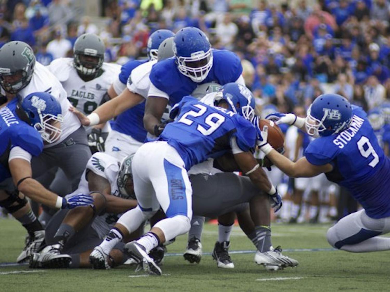 The Bulls defense forces a fumble on Eastern Michigan in the their 42-14 victory over the Eagles on Oct. 5 2013 in UB Stadium. Buffalo faces the Eagles Saturday in Ypsilanti, Michigan.&nbsp;Chad Cooper, The Spectrum