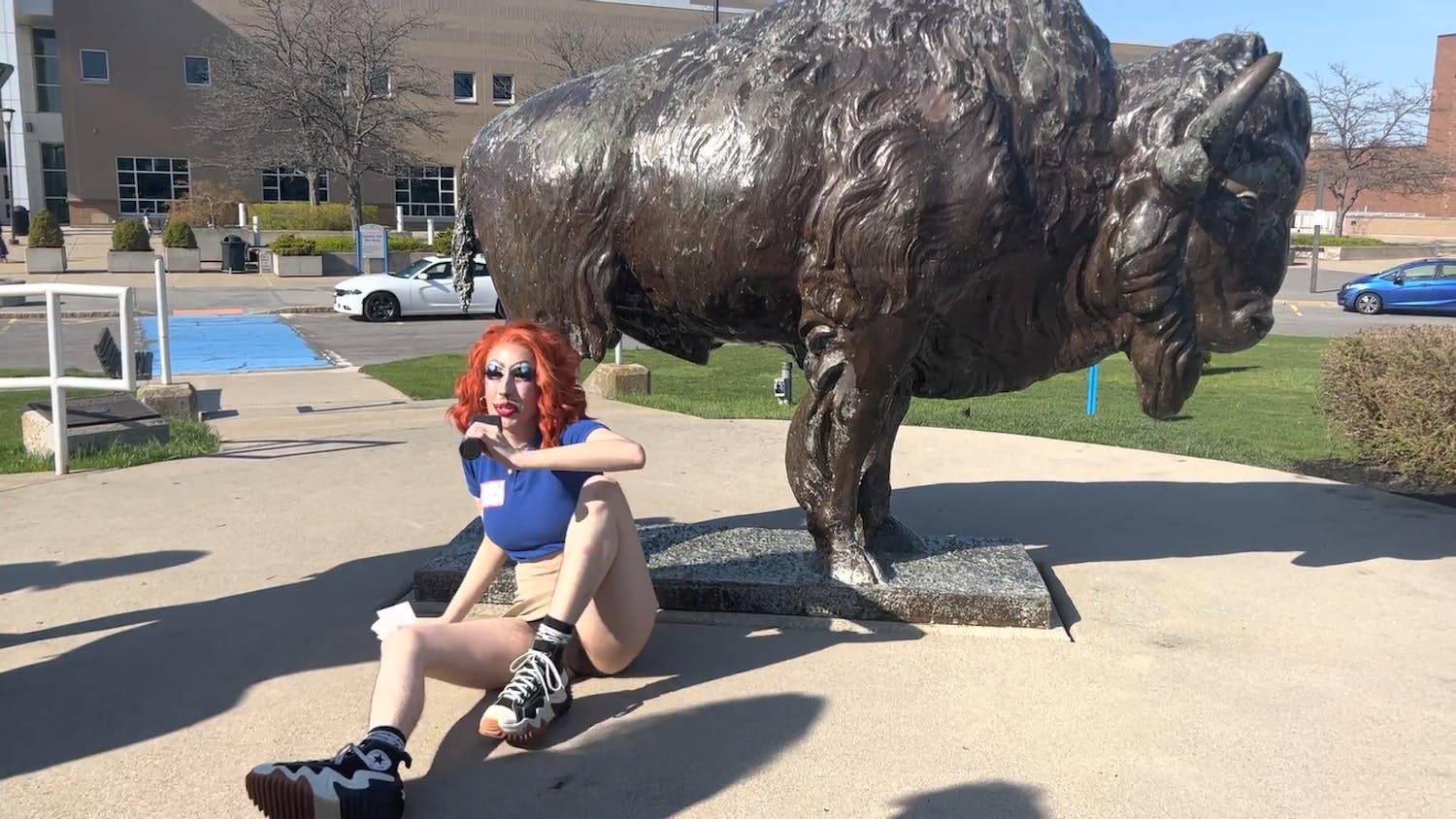 Mx. Ology demonstrated an invented UB tradition on their tour: rubbing the bull’s penis to ensure a timely graduation.&nbsp;