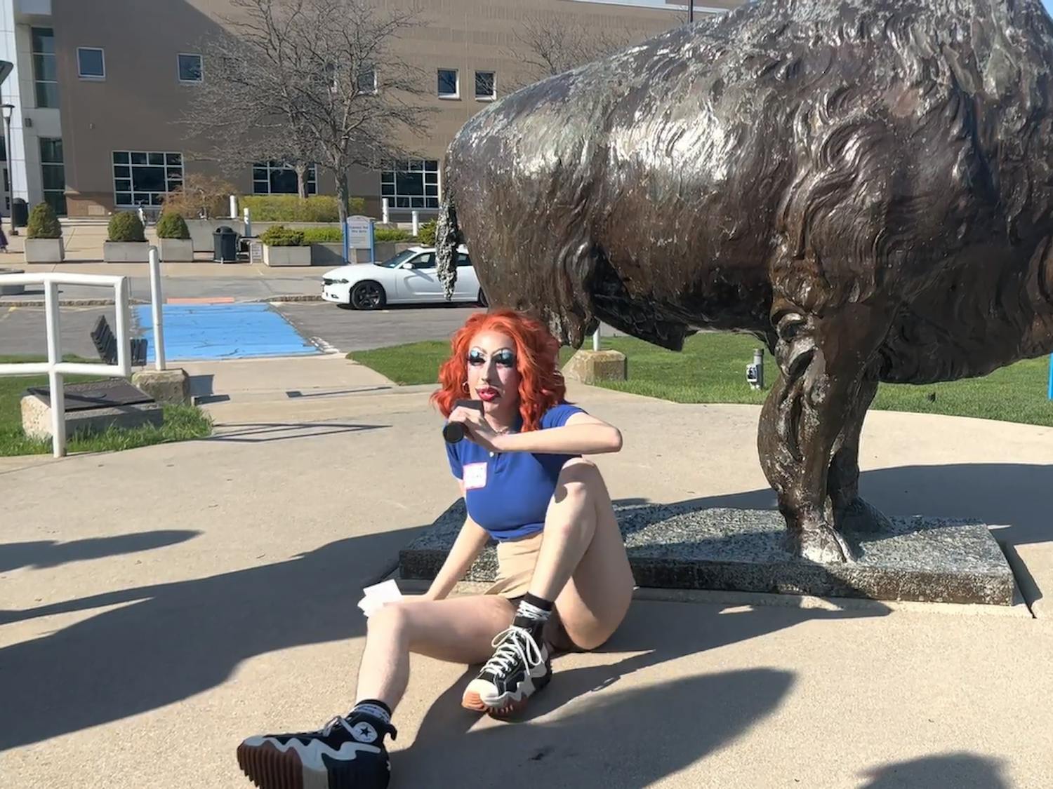 Mx. Ology demonstrated an invented UB tradition on their tour: rubbing the bull’s penis to ensure a timely graduation.&nbsp;
