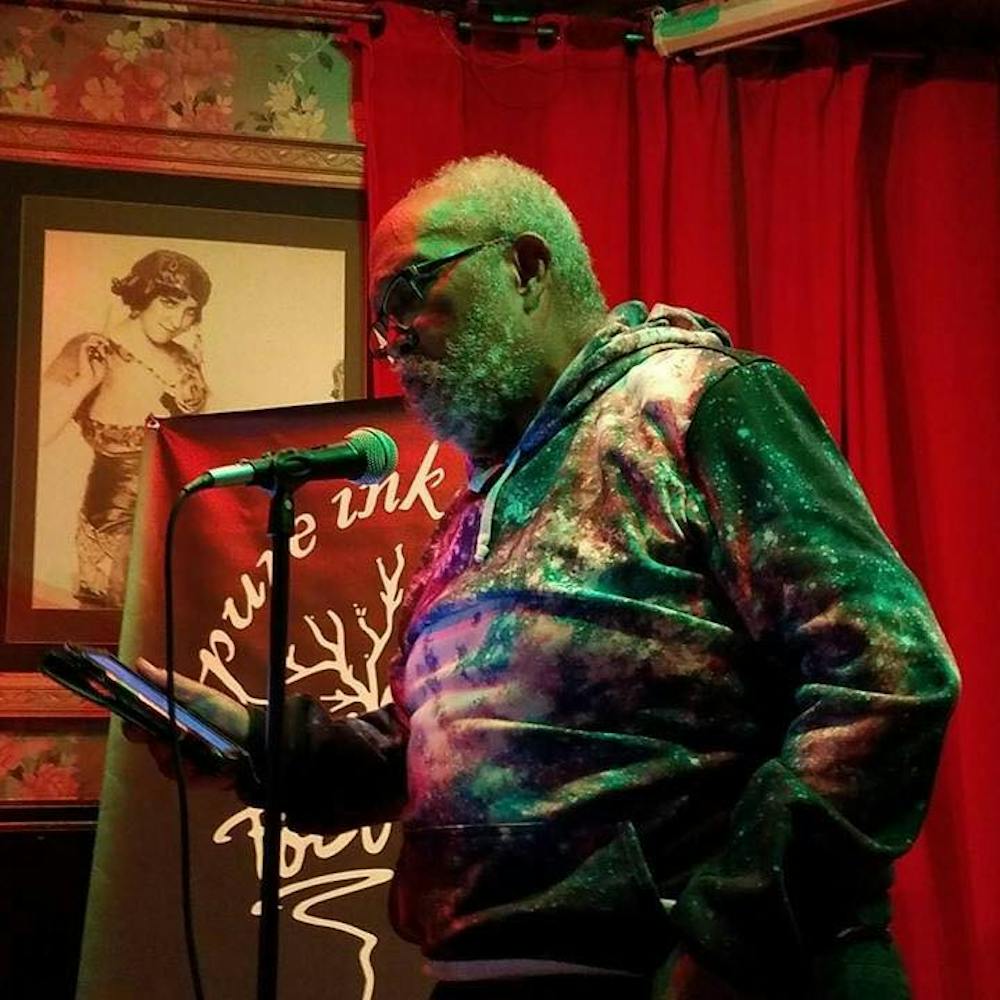 Dr. Scott Williams reads at the Pure Ink poetry slam at Buffalo’s Gypsy Parlor. Friends of Williams said his readings are  unlike anything they’ve heard before.
