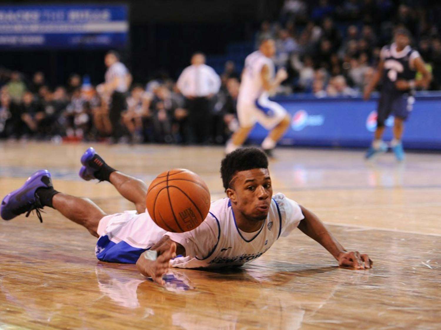 Shannon Evans dives and recovers a loose inbound pass by Akron to ice the game for the Bulls in Alumni Arena on Feb. 24.