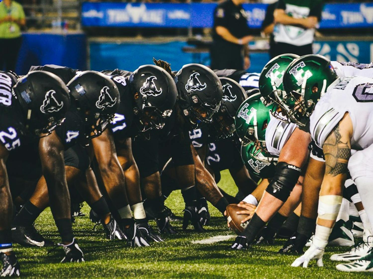 The UB defensive line meets Eastern Michigan at the line of scrimmage. Senior defensive end Chuck Harris, wearing number 41, finished the best game of his collegiate career with eight tackles, two and a half sacks and a forced fumble.