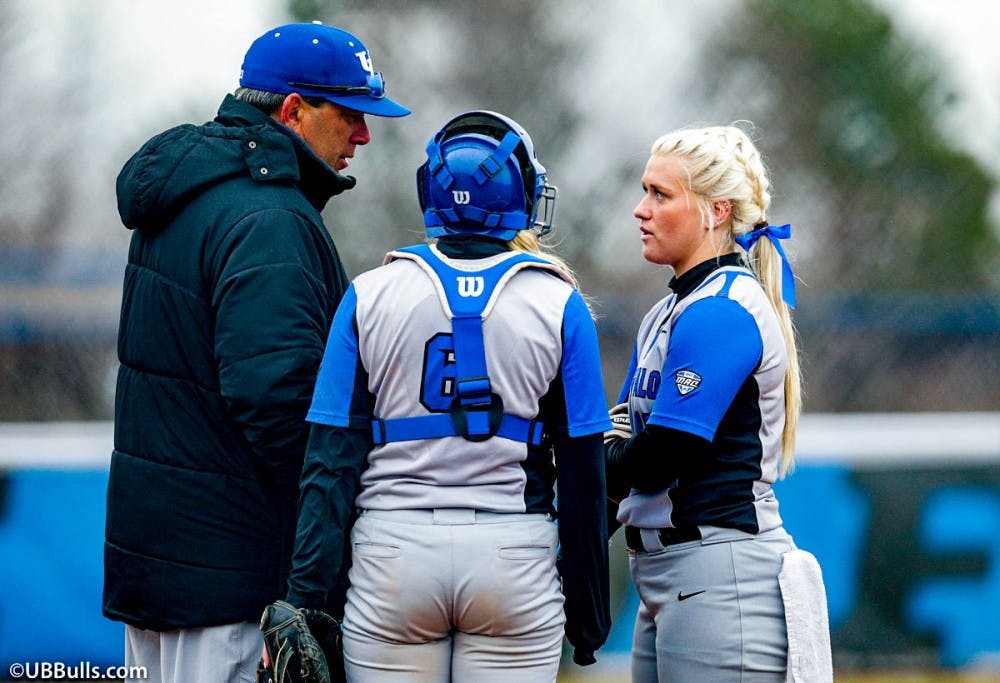 <p>Head coach Mike Roberts talks to senior pitcher Ally Power on the mound. Roberts is looking to turn the program around after going 9-45 last season.</p>