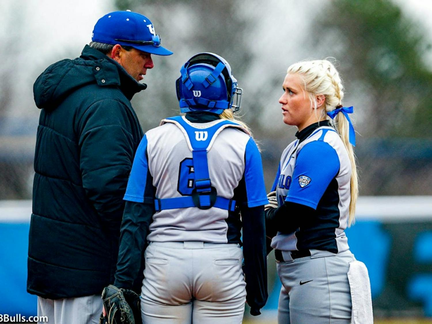 Head coach Mike Roberts talks to senior pitcher Ally Power on the mound. Roberts is looking to turn the program around after going 9-45 last season.
