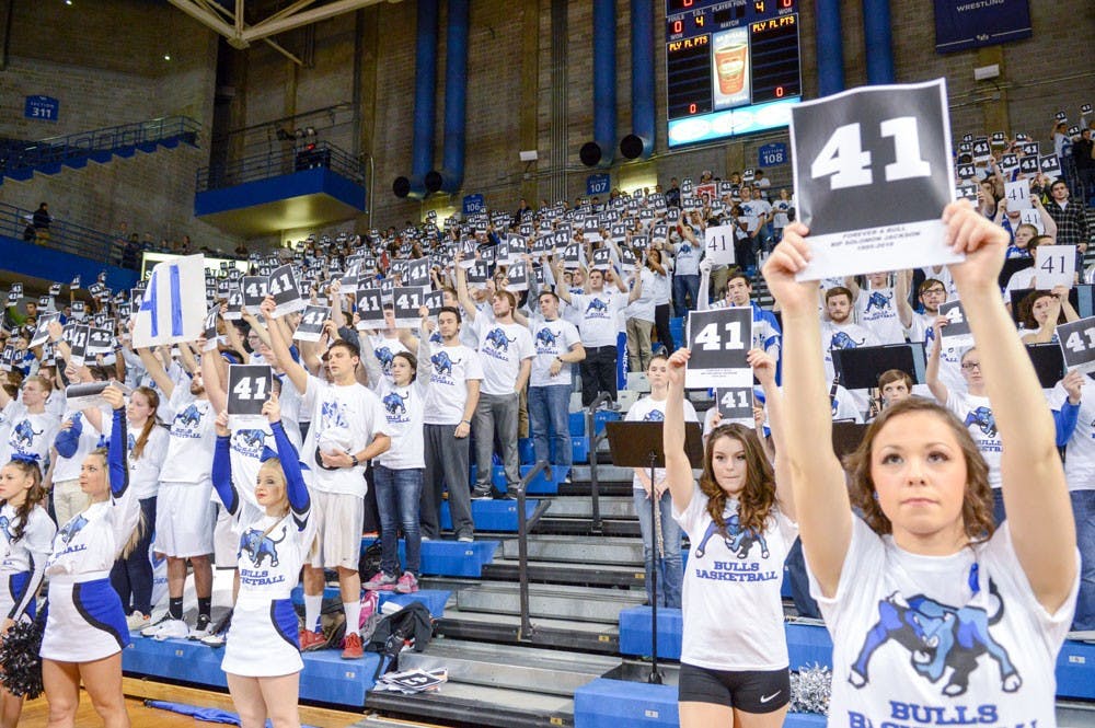 <p>Members of the Dazzlers, UB cheerleaders&nbsp;and True Blue hold signs with the No. 41 during a moment of silence on Tuesday night to honor former UB football player Solomon Jackson. Jackson died on Monday night following a medical emergency suffered at practice on Feb. 22.&nbsp;</p>