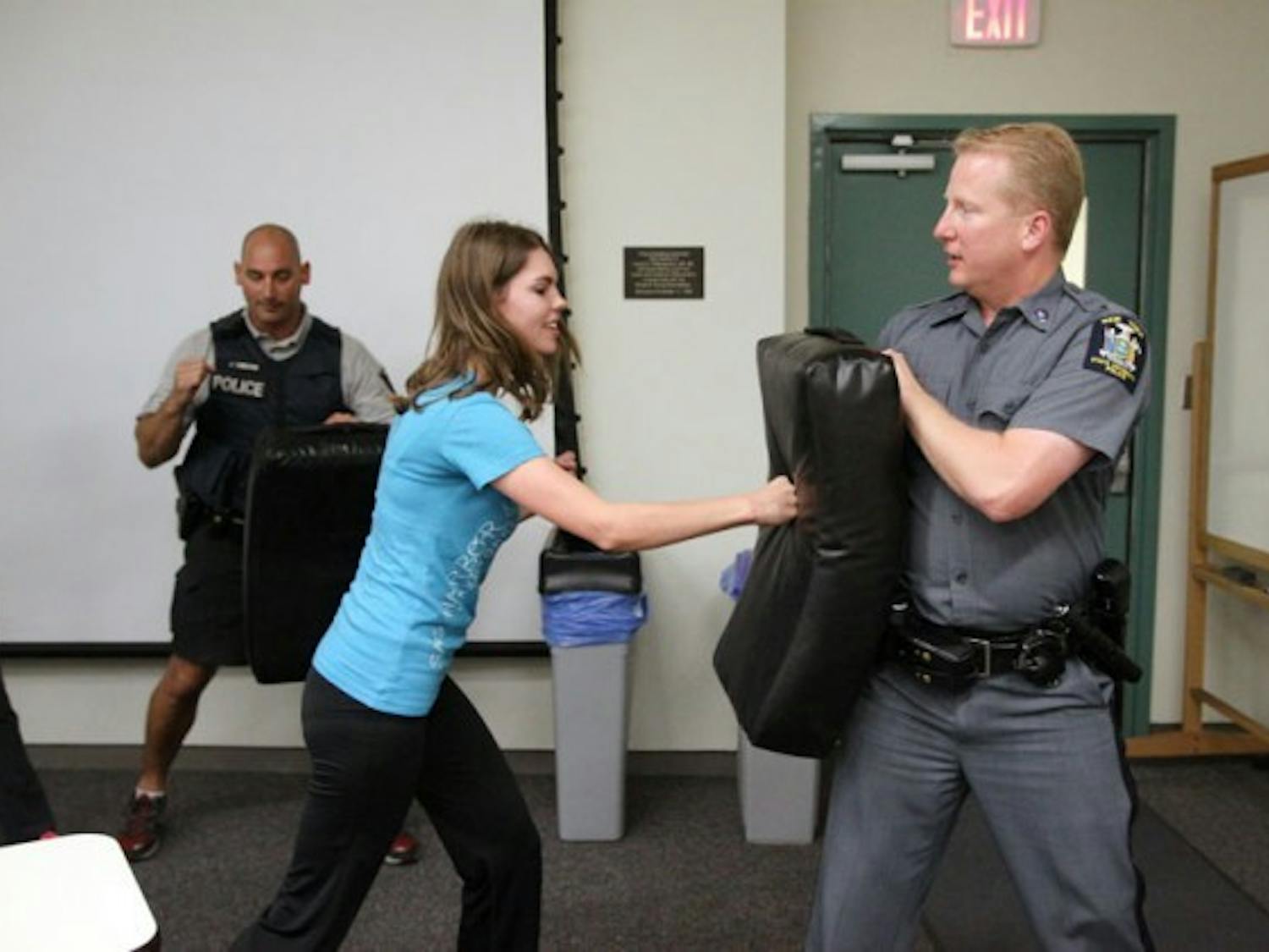 Kristin Jorgali, president of UB Women in Management club (left) and UB police officer Sergio Disanto (right) practice self-defense. According to Disanto, situational awareness is the key to effective self-defense.&nbsp;Derek Drocy, The Spectrum