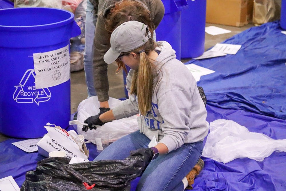 <p>UB students from the Sustainable Urban Environments digging through waste at Tri-Main to help improve their waste process.</p>