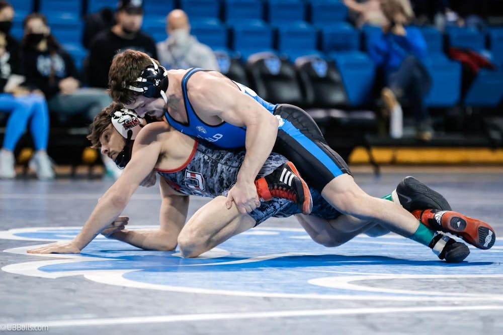 <p>Graduate John Arceri (blue singlet) clinched an NCAA Tournament berth Saturday at the Mid-American Conference Championships.</p>