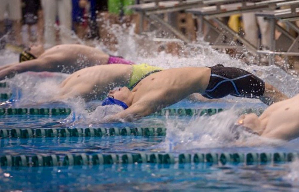 <p>Freshman swimmer Joey Puglessi performs a backstroke. Puglessi is among six swimmers and divers being represented by attorney Richard Lydecker.</p>