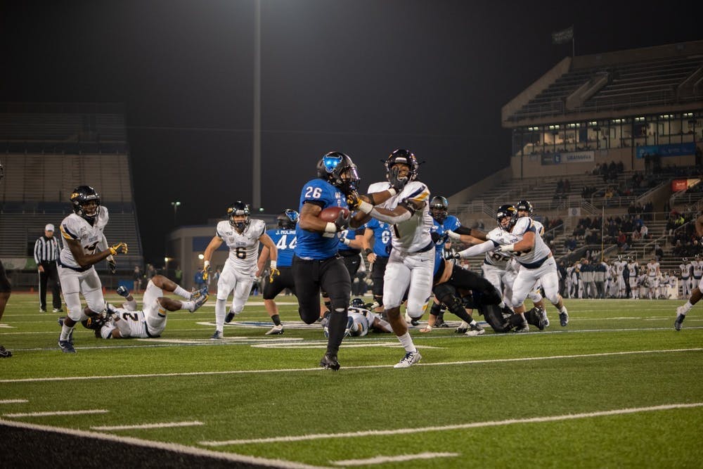 Running back Jaret Patterson holds a defender off him.