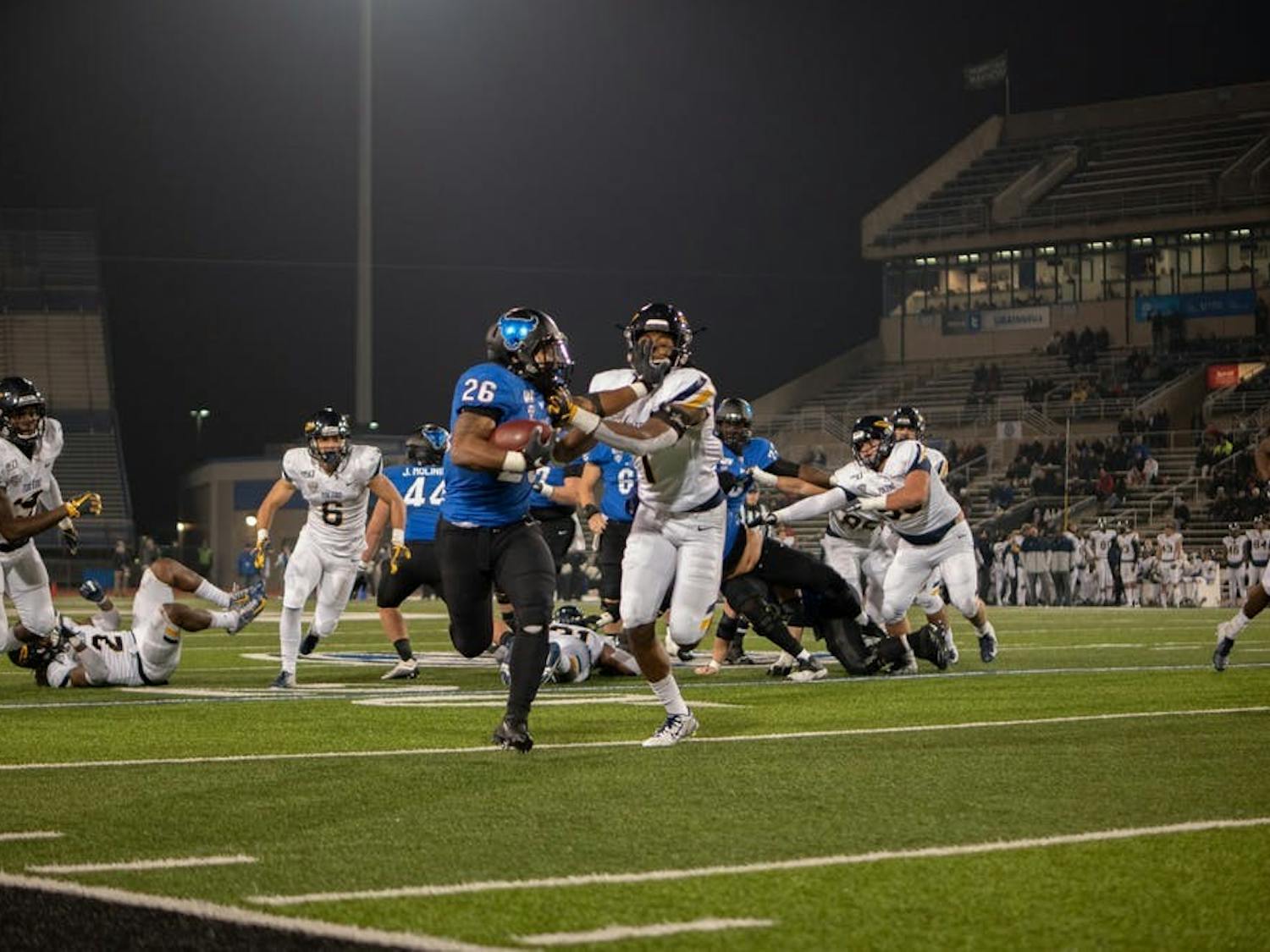Running back Jaret Patterson holds a defender off him.