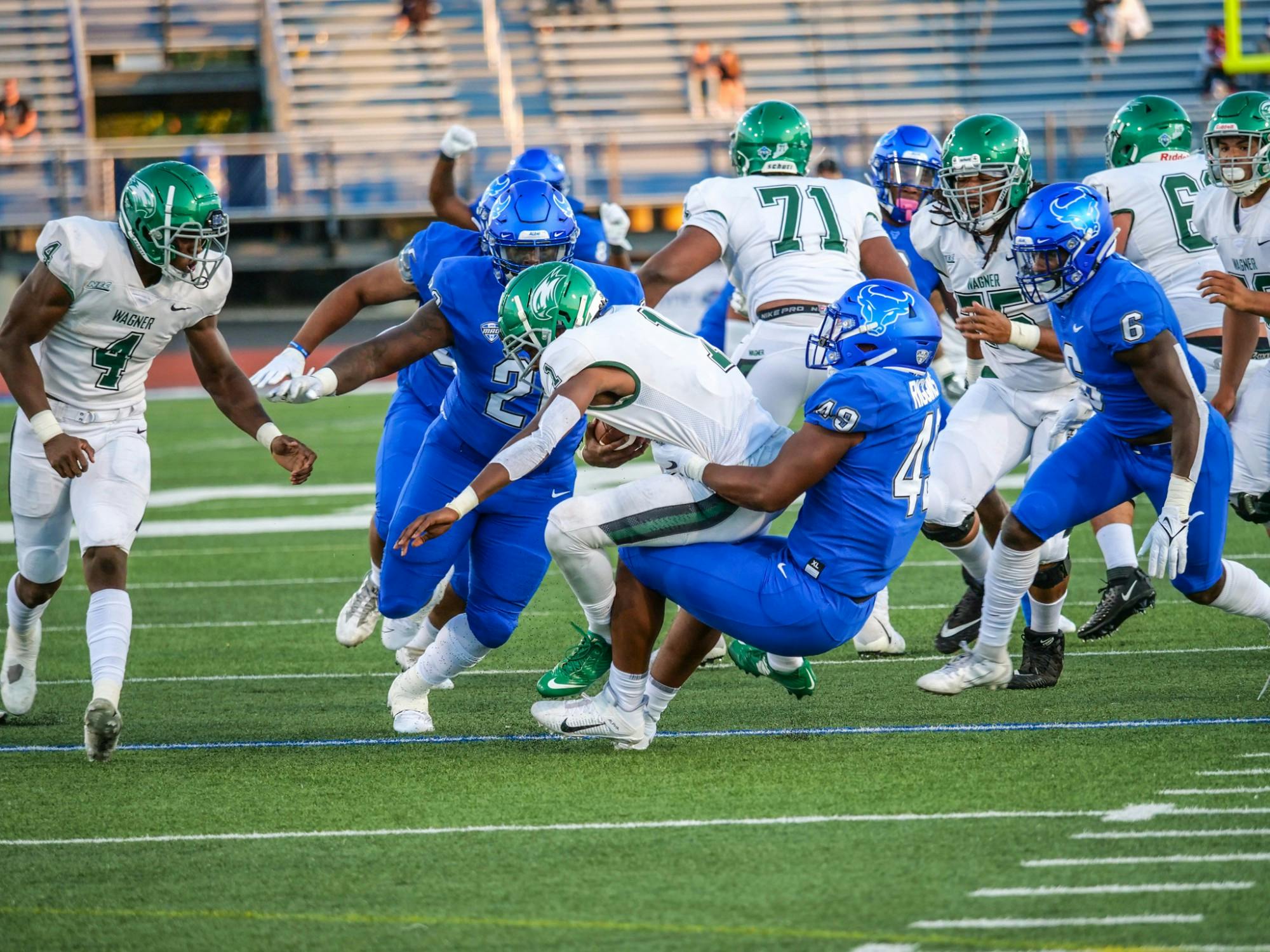 Defensive end Taylor Riggins (49) records his first sack of the season on Wagner quarterback Jaalon Frazier. The Bulls lost to Miami (OH), 48-18, at Yager Stadium in Oxford, OH Tuesday night.