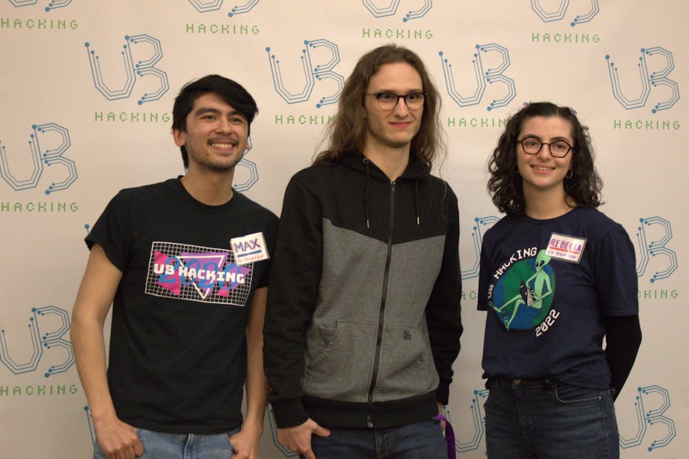 First-place winner Nick Brown (center) poses for a photo with event co-directors Max Farrington (left) and Rebecca Ramhap (right).