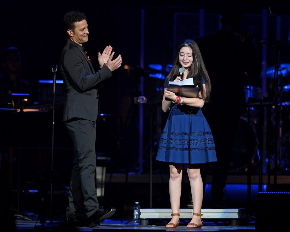 <p>Avery Anger, a freshman at Marjory Stoneman Douglas High School, singing with singer Justin Guarini at the From Broadway With Love benefit concert.&nbsp;Avery’s father and UB Alum, Lonny Anger, is the director and vice president of media relations for Shine MSD, a nonprofit organization that benefits those affected by the Parkland shooting.</p>