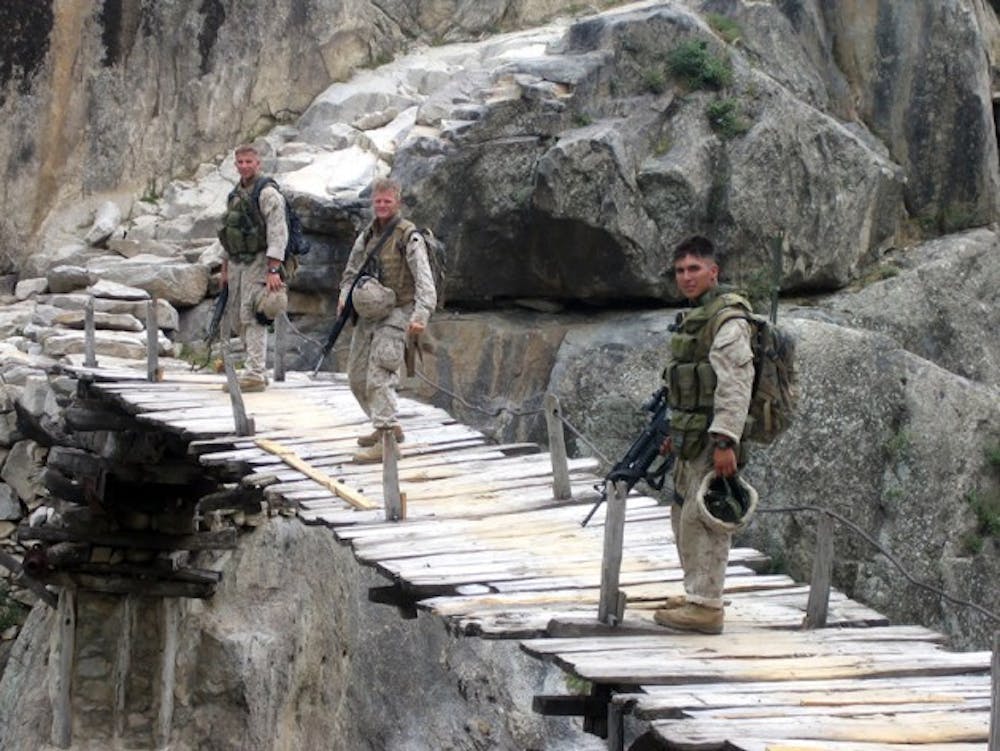 Julian Chinana (right) Matt Brinker (middle) Kyle Feeney (left) during their time in Afghanistan. Between 2002 and 2006, Chinana served in both Iraq and Afghanistan as a Marine Sniper. Now, the student veteran uses photography to cope with the memories of war.&nbsp;Courtesy of Julian Chinana&nbsp;