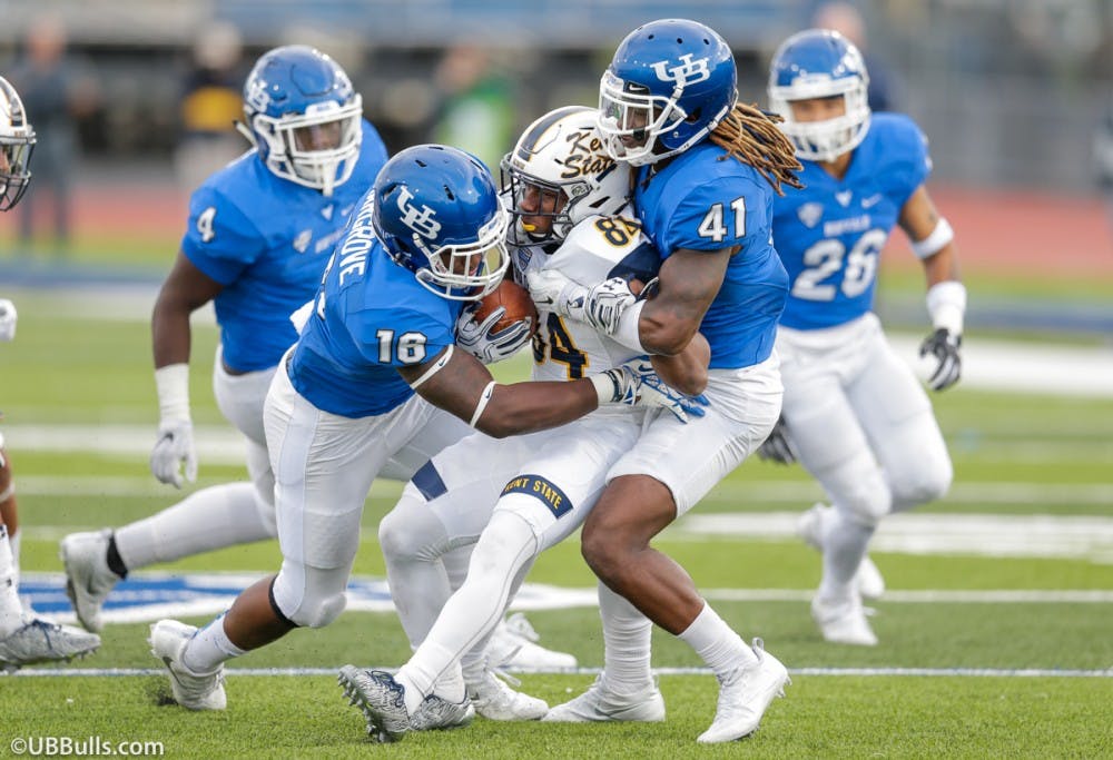 Junior linebacker Ishmael Hargrove and senior cornerback Boise Ross make a tackle against Kent State.