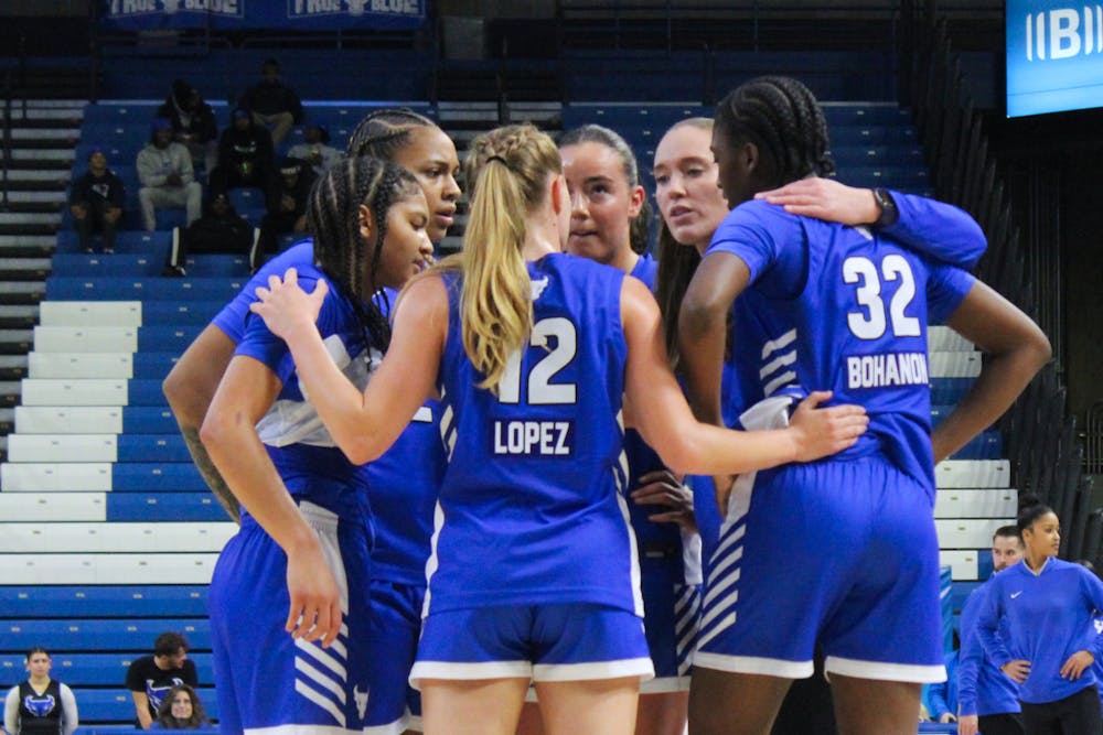 Women's basketball team huddle.