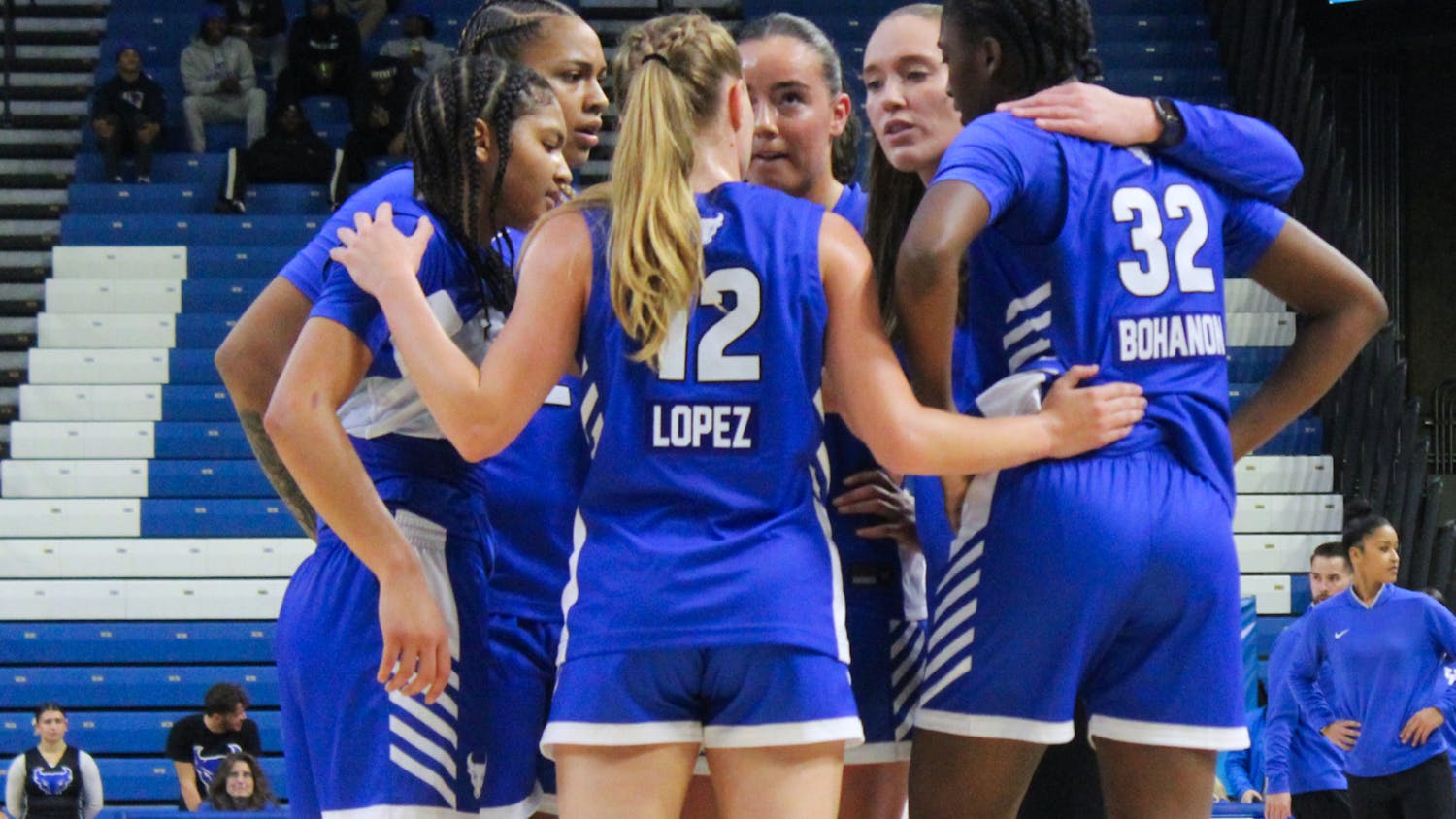 Women's basketball team huddle.