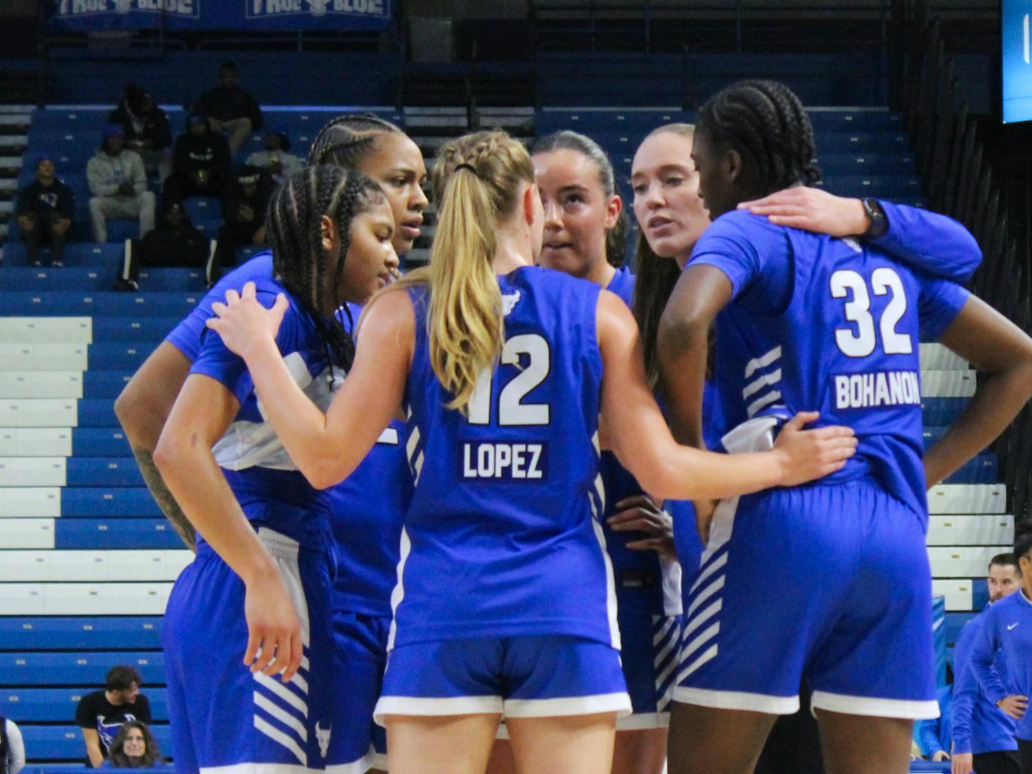 Women's basketball team huddle.