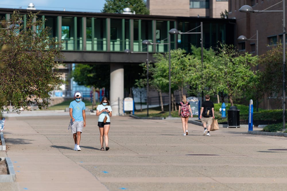 Students walk along the Academic Spine in September 2020.