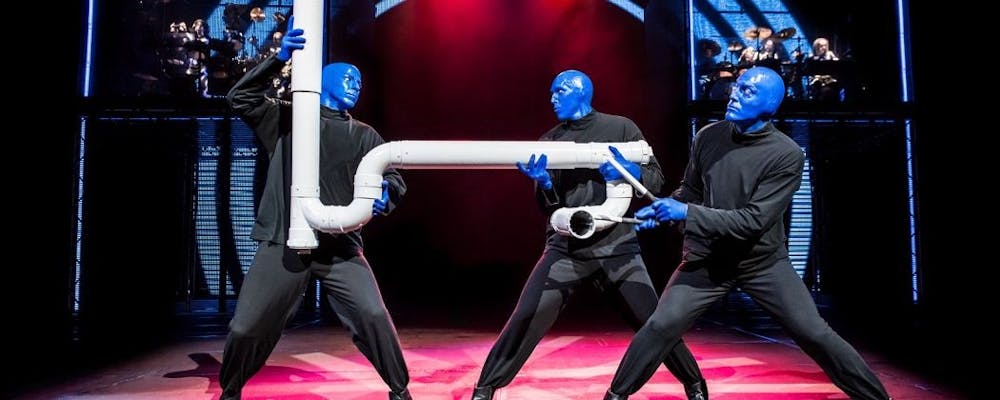 <p>The three blue men playing with one of their signature instruments, the drumbone.</p>