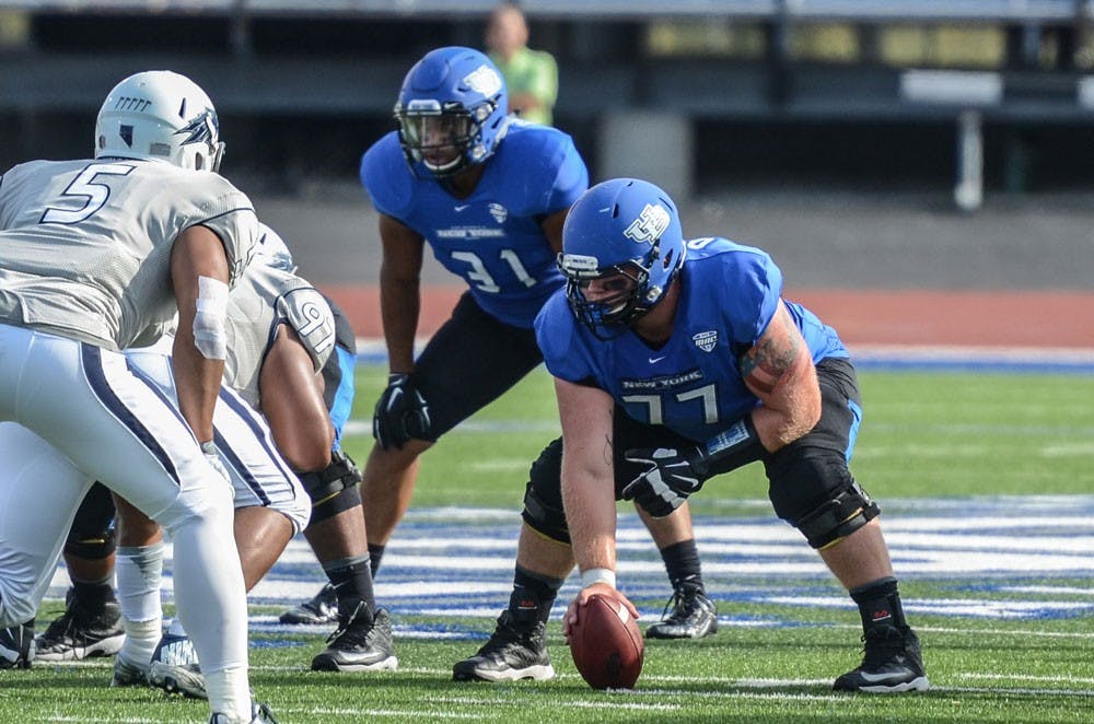 <p>Freshman center James O'Hagan prepares to snap the ball for the Bulls football team. O'Hagan gained 20 pounds by cutting out unhealthy foods and changing his diet.&nbsp;</p>