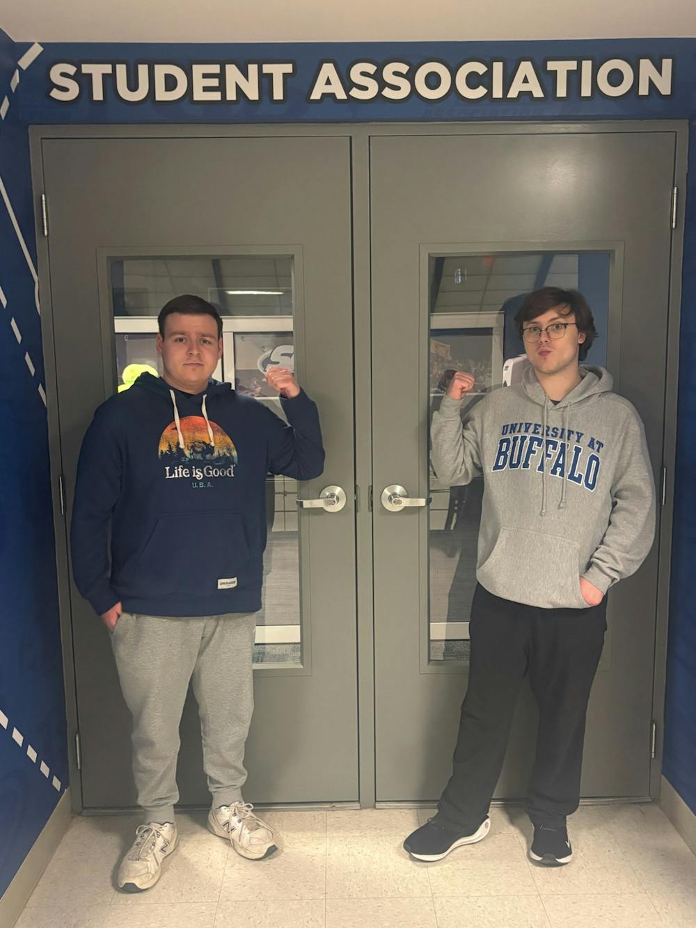 A photo of SA Senators Grant Peterson (right) and Joshua Brodsky (left) in front of the undergraduate Student Association's office doors