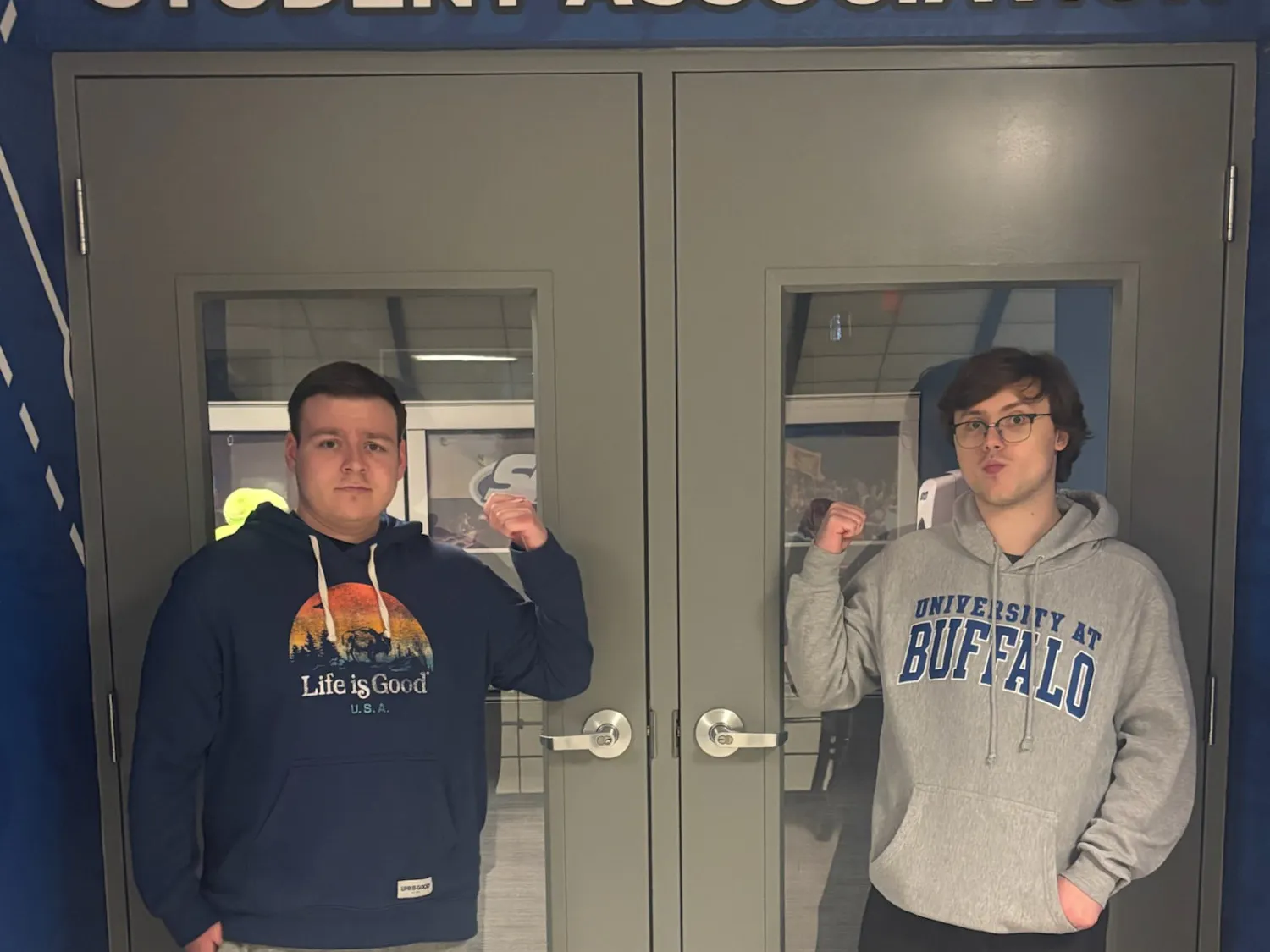 A photo of SA Senators Grant Peterson (right) and Joshua Brodsky (left) in front of the undergraduate Student Association's office doors