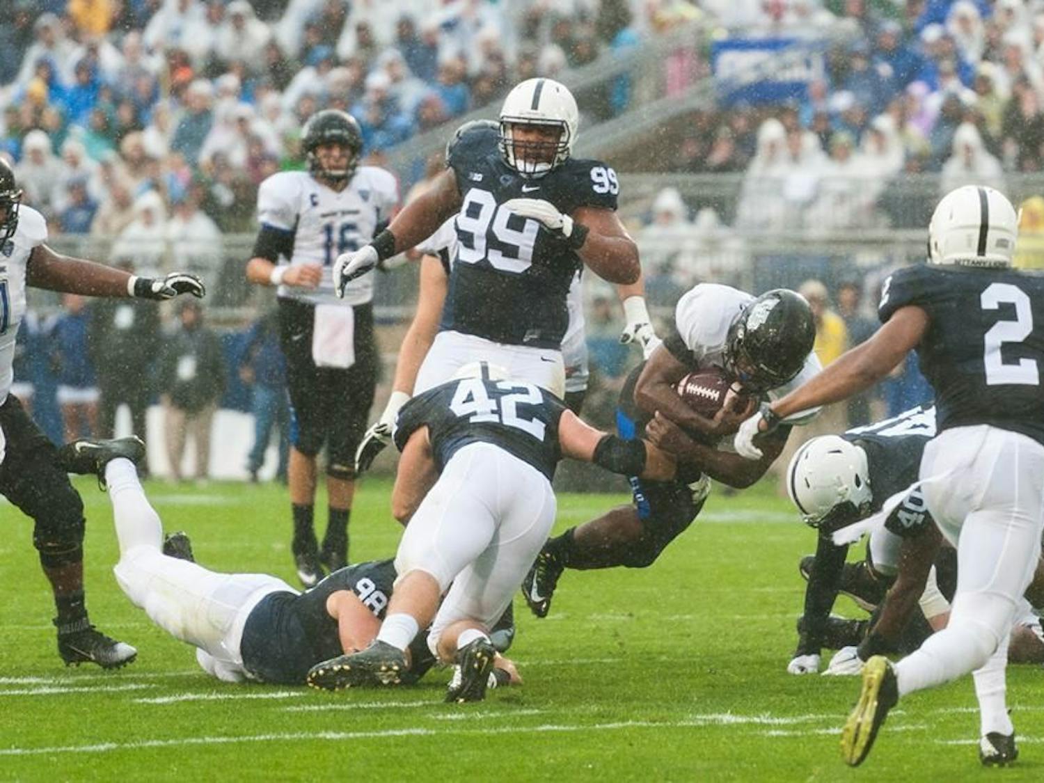Buffalo senior running back Anthone Taylor gets tackled in the Bulls' 27-14 loss to Penn State Saturday at Beaver Stadium.