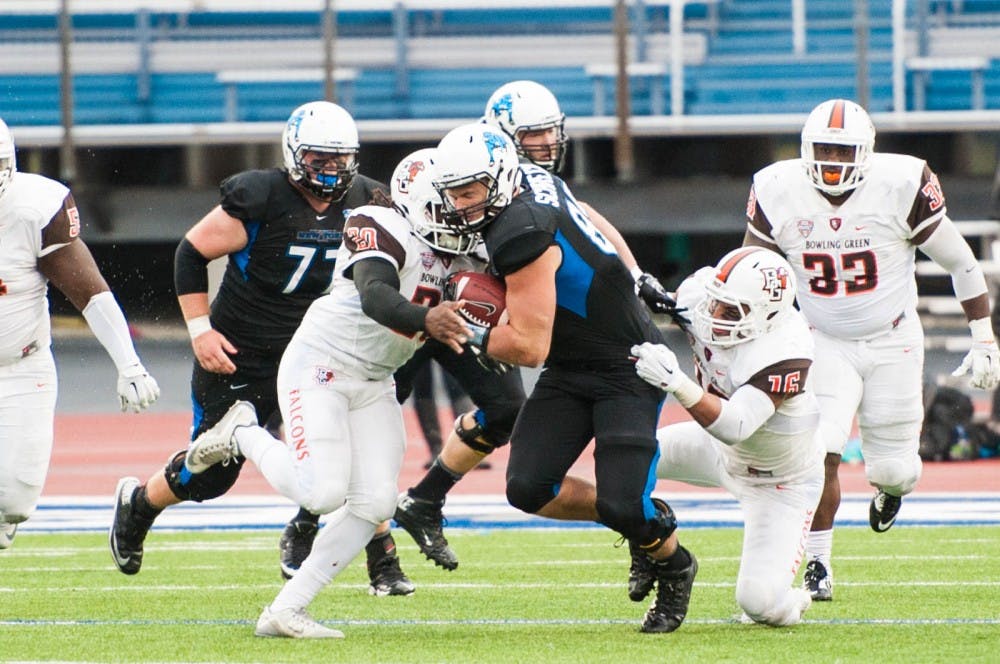 <p>Junior tight end Mason Schreck gets tackled during Buffalo's 28-22 loss at UB Stadium Saturday. The Bulls' wide receivers and tight ends received a B+ in their 18-17 win over Kent State.&nbsp;</p>