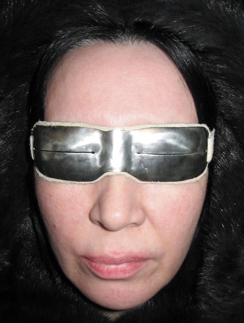 Edʼiiý [sakha] - auntie, wearing silver 925 rectangle Arctic snow goggles in ivory suede leather @ursuuna.archive on instagram
