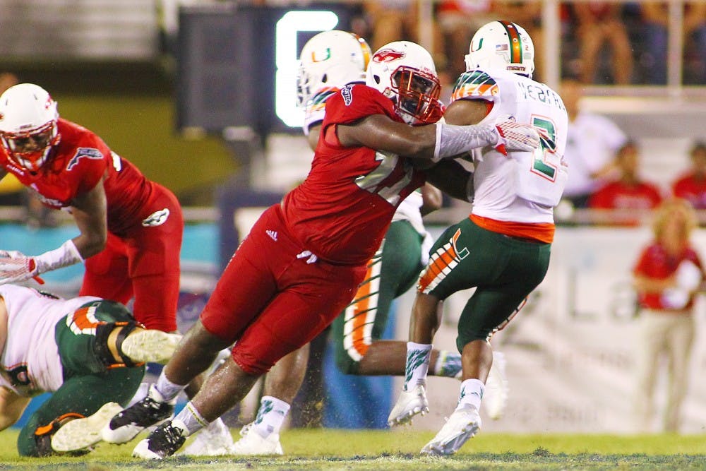 <p>Florida Atlantic senior defensive tackle Trevon Coley makes a tackle against Miami Florida last week. The Bulls face the Owls on the road this week. </p>