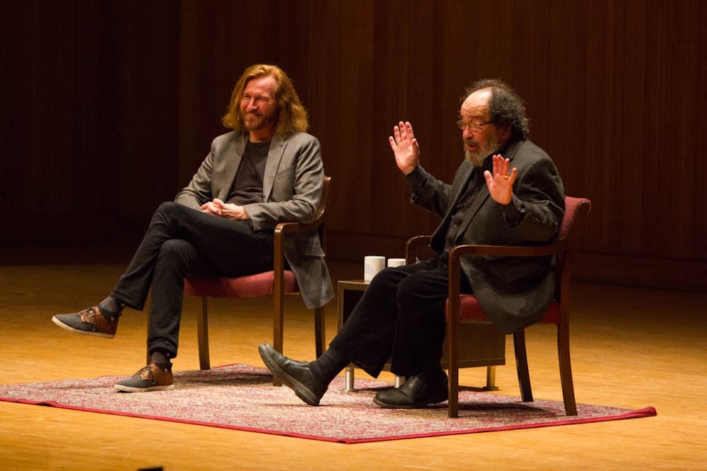 Tom Toles (left) speaks with his friend and SUNY Buffalo Arts initiative co-director Bruce Jackson (right) at Slee Hall on April 14, 2016.