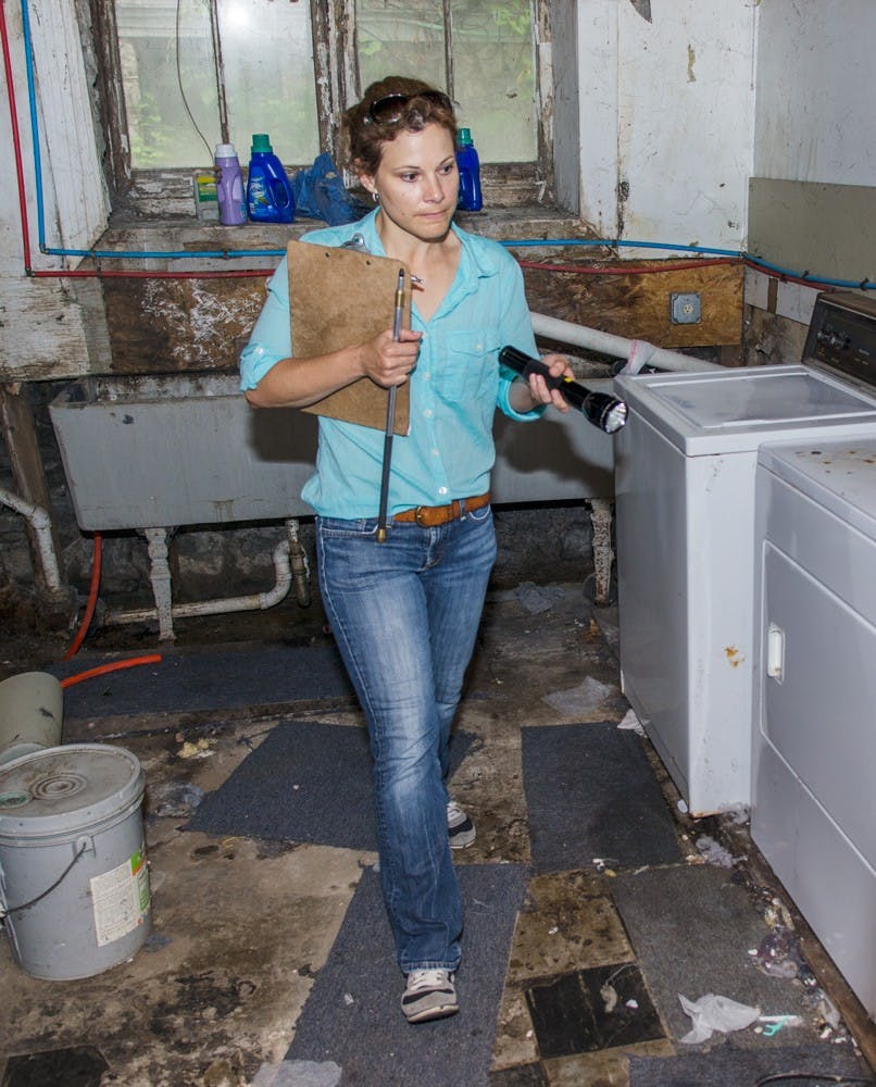 Buffalo housing inspector Cathy Amdur walks through a Northrup Place basement. Buffalo city inspectors and Daniel Ryan, director of Off Campus Student Services, conducted housing blitzes in the University Heights on Saturday, inspecting roughly 35 homes on Winspear Avenue and Northrup Place.