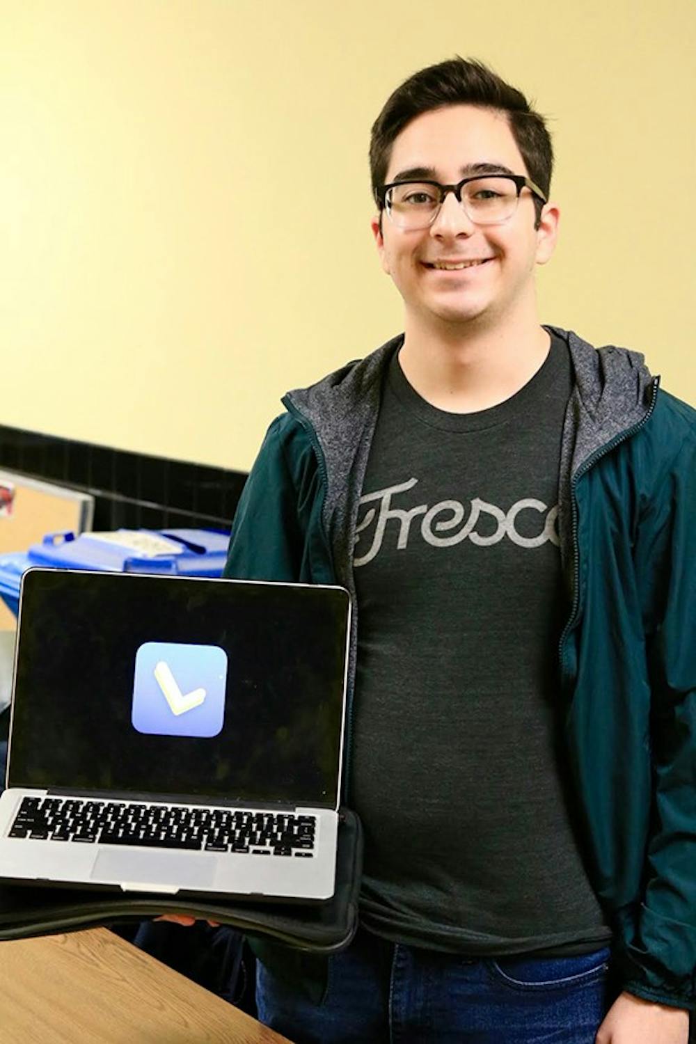 <p>Arthur De Araujo, sophomore computer science major, poses next to the icon for his Lecture Buddy app. The app translates a lecture into text and highlights important keywords.</p>