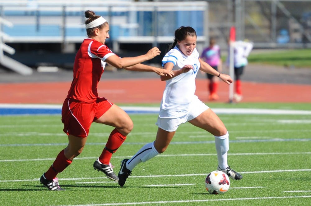 <p>Sophomore midfielder Moira Petrie takes on a defender earlier this season. The women's soccer team fell 1-0 to Western Michigan in the MAC Semifinals Friday.&nbsp;</p>