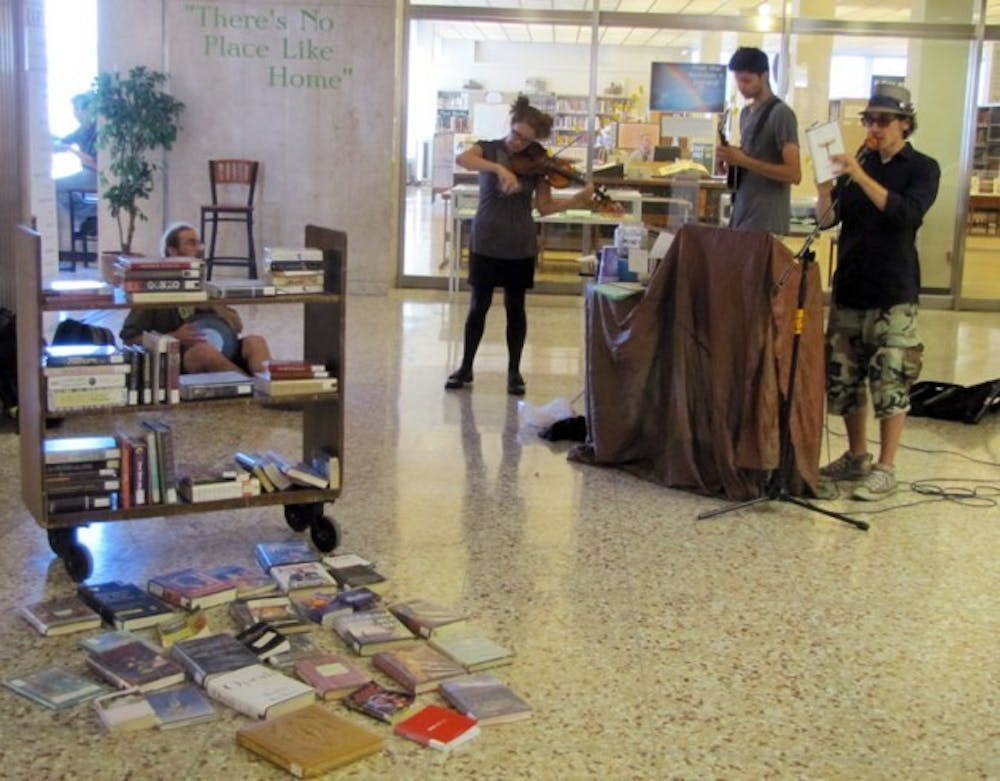 Local &ldquo;transcendental rock poetry&rdquo; group, Bourbon and Coffee, performs music and readings at echo Art Fair, held on Sept. 6 and 7 at the Buffalo and Erie County Central Library in downtown Buffalo. The Fair brought together local and national artists to exhibit their work.
Emma Janicki, The Spectrum