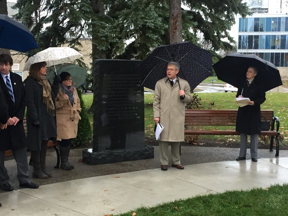 <p>Provost Zukoski stood next to the newly implemented monument as he dedicated the memorial garden to those buried at the former Erie County Poorhouse. Zukoski spoke about the history of the poorhouse and its importance to the UB community at the ceremony.</p>