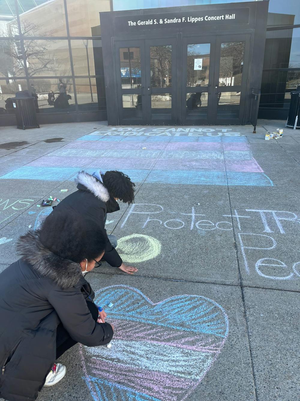 <p>Students used screen-printing and sidewalk chalk to protest Knowles' speech outside of Slee Hall.&nbsp;</p>