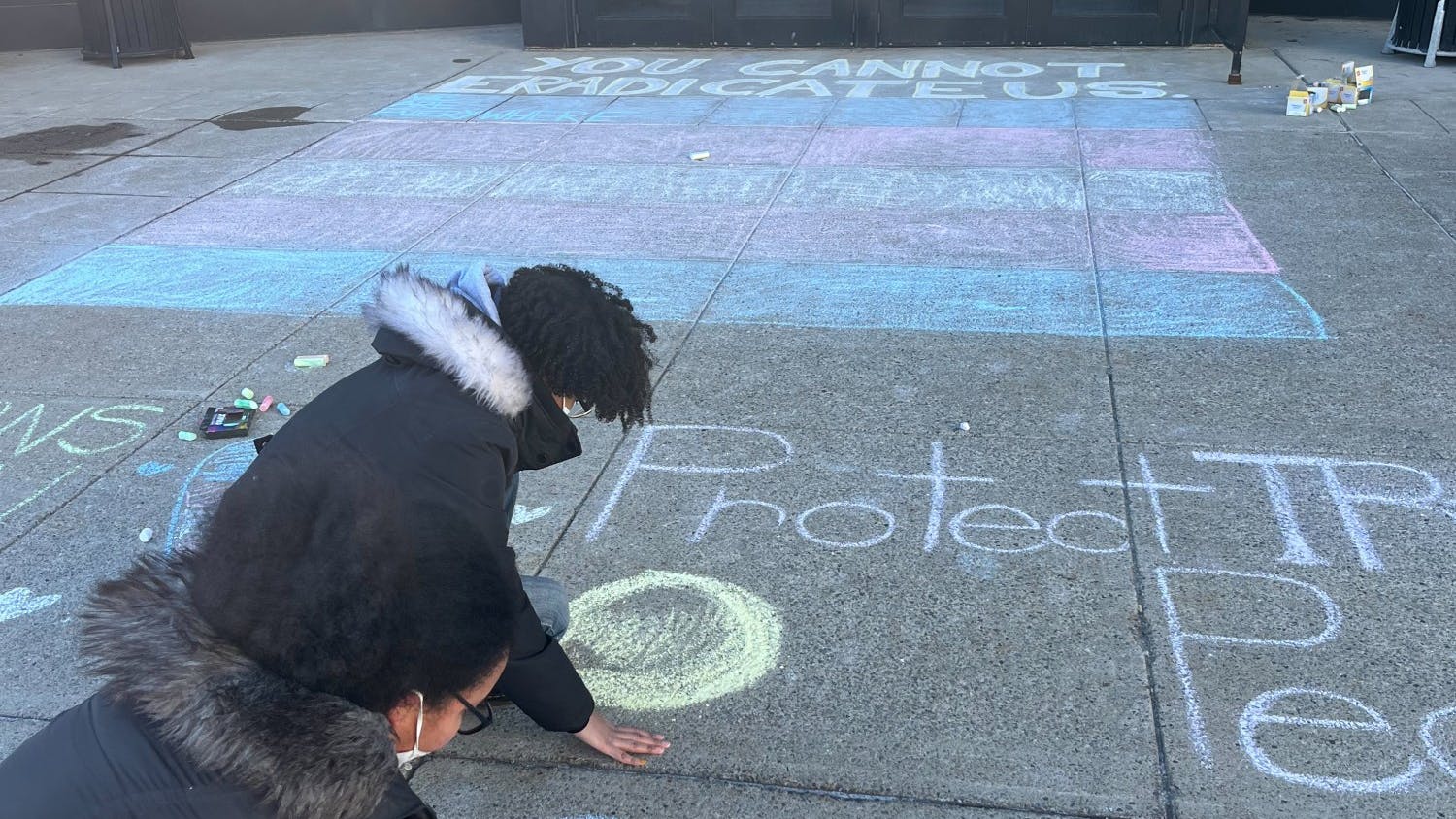 Students used screen-printing and sidewalk chalk to protest Knowles' speech outside of Slee Hall.&nbsp;